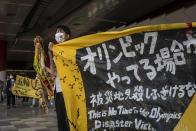 <p>An anti-Olympics protester demonstrates against the Tokyo Olympics on July 23, 2021 in Tokyo, Japan. Protesters gathered to demonstrate against the Olympic Games amid concern over the safety of holding the event during the global coronavirus pandemic as well as the cost incurred. (Photo by Yuichi Yamazaki/Getty Images)</p> 