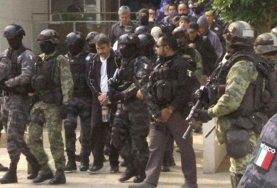 FILE - In this May 2, 2017, file photo, Damaso Lopez, a leader in Mexico's Sinaloa drug cartel, is escorted by police after his capture at an upscale apartment building in Mexico City. Lopez, a top lieutenant to drug kingpin Joaquin "El Chapo" Guzman, was sentenced to life in prison in a Virginia courtroom on Friday, Nov. 30, 2018. (AP Photo/Jorge Barrera, File)