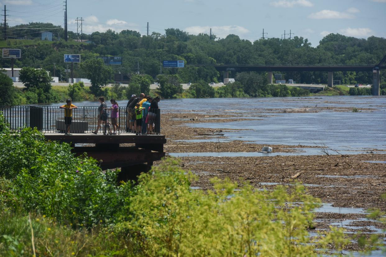 An image shows people looking at the Missouri River's high water levels on Sunday, June 23, 2024 near Sioux City proper.