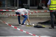 Police investigators work at the crime scene after a knife attack in a supermarket in Hamburg, Germany, July 28, 2017. REUTERS/Morris Mac Matzen