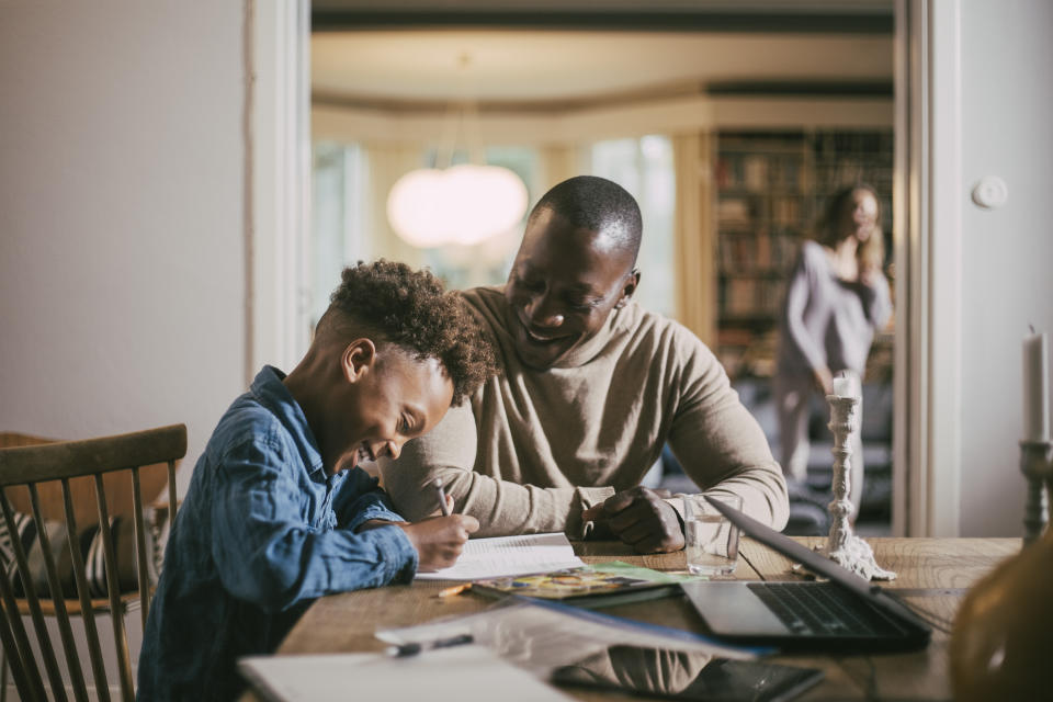 Dad and son doing homework together