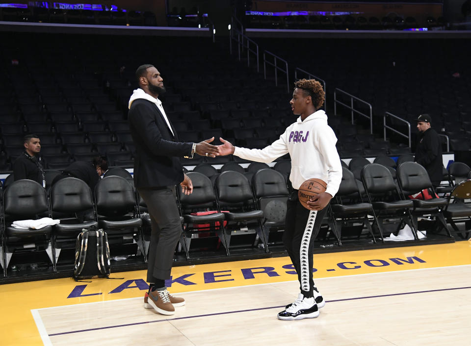 LeBron James his son LeBron James Jr., on the court after the Los Angeles Clippers and Los Angeles Lakers basketball game at Staples Center.