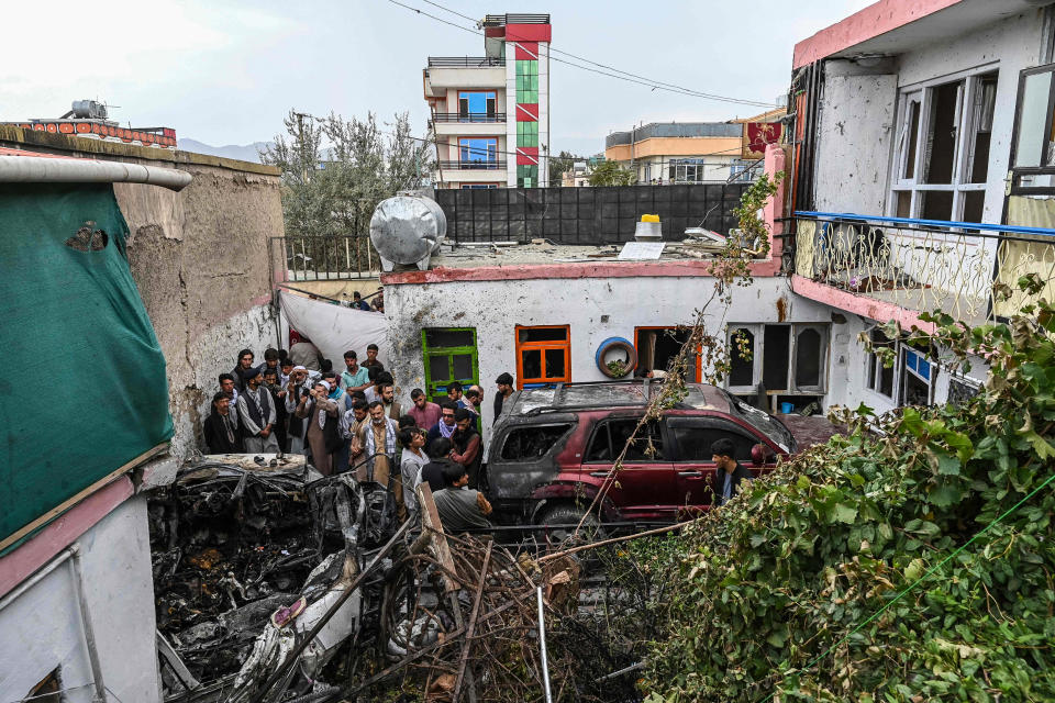 Image: Residents and family members gather next to a damaged vehicle inside a day after a U.S. drone airstrike in Kabul on Sunday. (Wakil Kohsar / AFP - Getty Images)