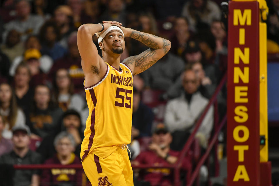 Minnesota guard Ta'Lon Cooper checks the scoreboard in the final seconds against Wisconsin during the second half of an NCAA college basketball game on Sunday, March 5, 2023, in Minneapolis. (AP Photo/Craig Lassig)