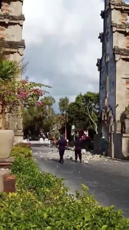 Debris from a partially collapsed gate blocks a road in Nusa Dua