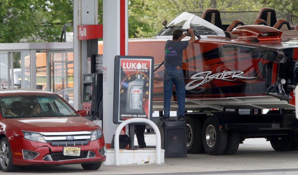 An offshore powerboat and a car get fueled up at the Lukoil station at Hooper Avenue and Polhemus Road in Toms River Friday, May 19, 2023.