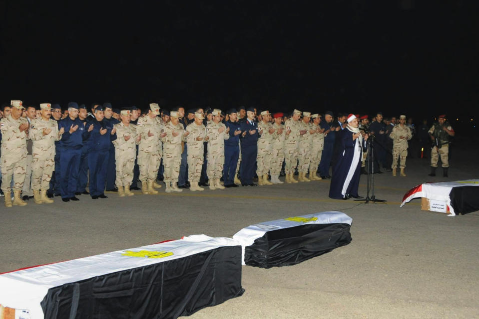 In this undated photo released by the Egyptian Defense Ministry, officers and soldiers pray during a funeral for several military personnel who were killed when a helicopter crashed in the Sinai Peninsula, at an undisclosed location in Egypt. Egypt's military spokesman, Col. Ahmed Mohammed Ali said that an Air Force helicopter crashed near the village of el-Kharouba in the northern Sinai Peninsula early Saturday, where troops are battling Islamic militants. An al-Qaida-inspired group based in the Sinai Peninsula has claimed responsibility for bringing down an Egyptian military helicopter in the lawless desert region. (AP Photo/Egyptian Defense Ministry via Facebook)