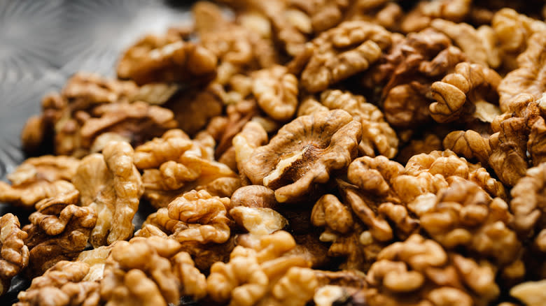 Peeled walnuts on gray surface