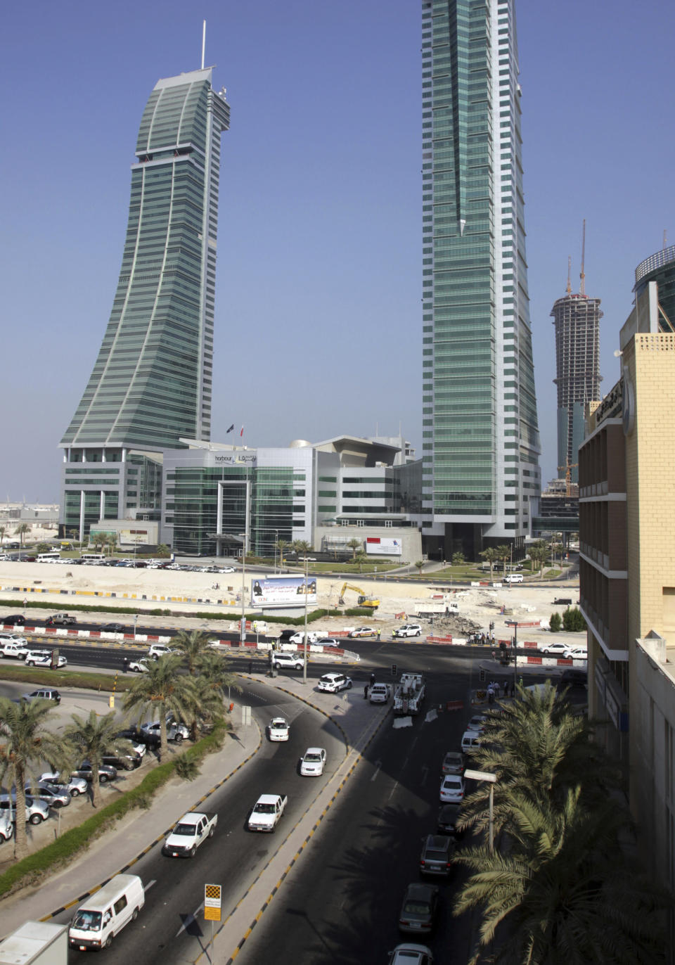 FILE - In this Sept. 21, 2011 file photo, traffic police divert traffic to ease congestion along roads in the capital of Manama, Bahrain. The island kingdom of Bahrain says it has become the second nation in the world to grant emergency-use authorization for the coronavirus vaccine made by Pfizer and its German partner BioNTech. The state-run Bahrain News Agency made the announcement on Friday, Dec. 4, 2020. (AP Photo/Hasan Jamali)