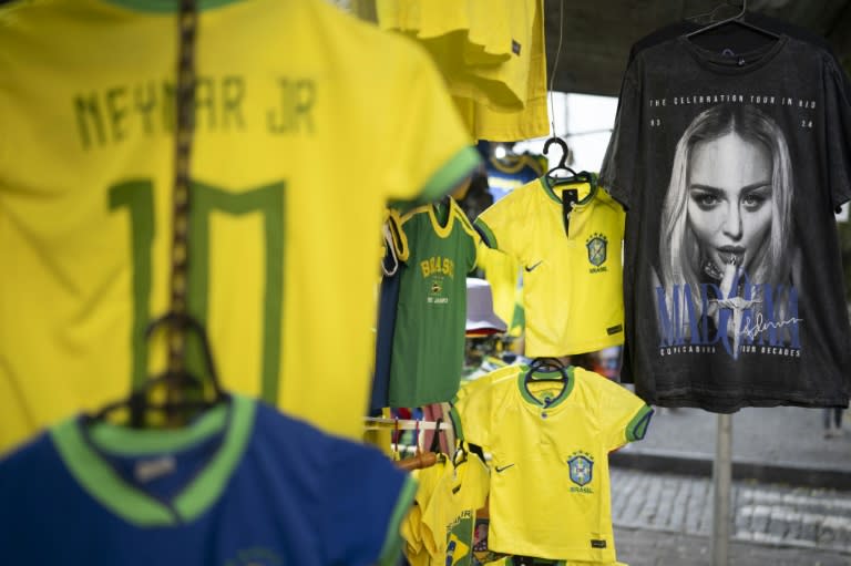 Madonna-related merchandise is sold along with soccer gear in a shop in central Rio on April 29, 2024 (Pablo PORCIUNCULA)
