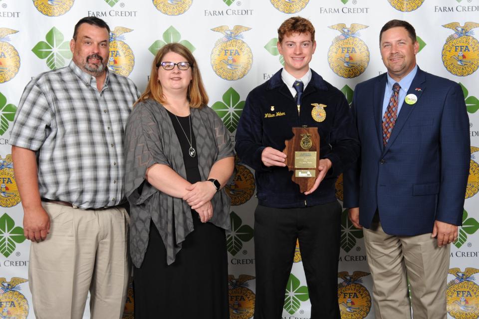 William Weber, second from right, with parents Dan and Heather Weber (left) and award sponsor Joe Webel of The Maschhoffs, LLC, was selected as the State FFA Proficiency wnner in Service Learning at the 94th annual Illinois State FFA Convention.