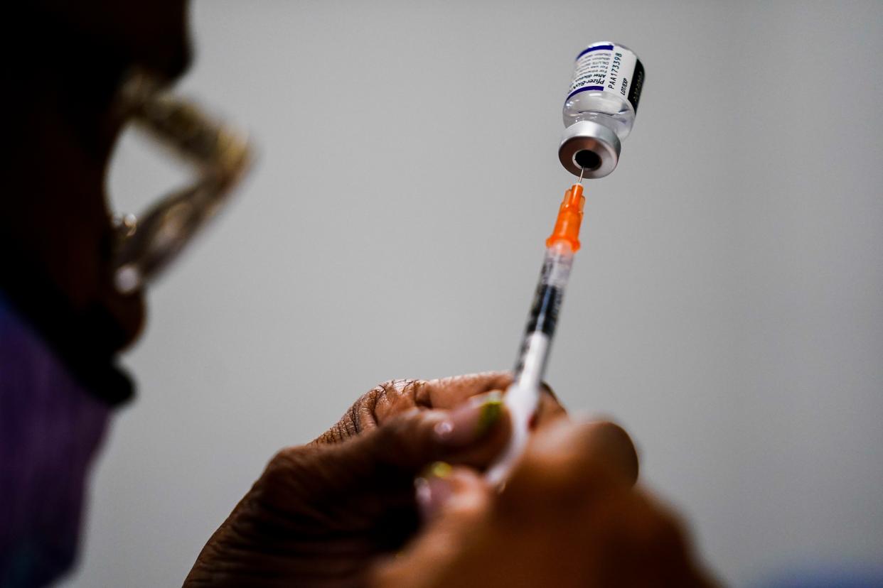 A syringe is prepared with the Pfizer COVID-19 vaccine at a vaccination clinic at the Keystone First Wellness Center in Chester, Pa. on Dec. 15, 2021. 