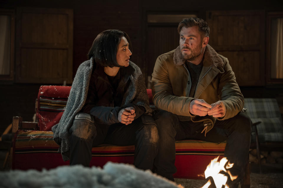 This image released by Netflix shows Golshifteh Farahani, left, and Chris Hemsworth in a scene from "Extraction 2." (Jasin Boland/Netflix via AP)