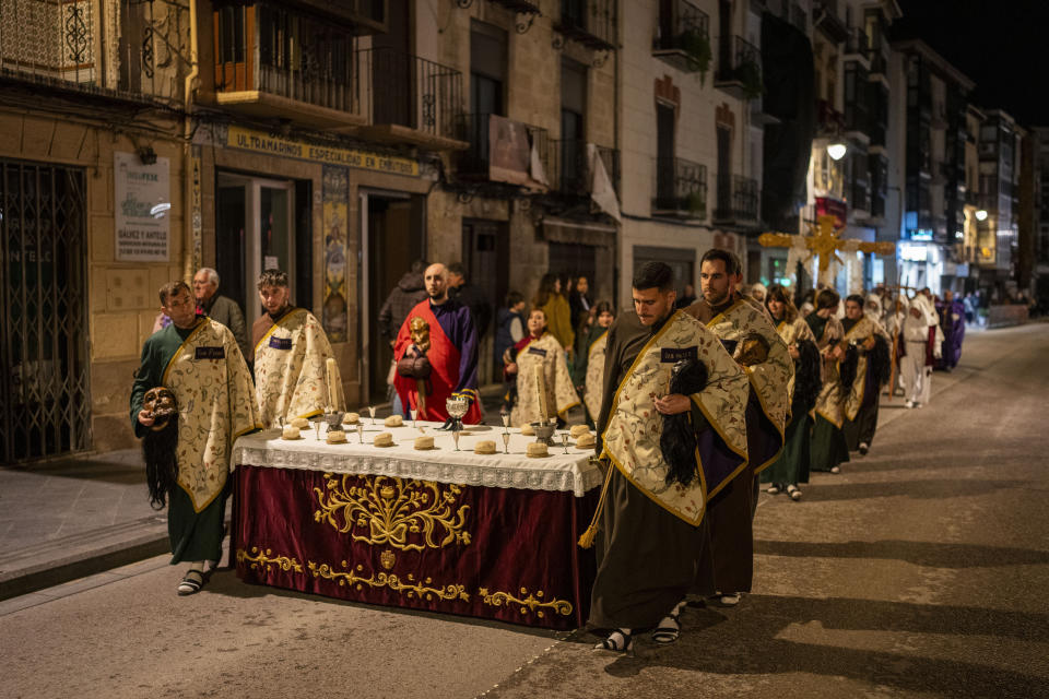 Members of the "Penitencia de los Apóstoles y Discípulos de Jesús" Catholic brotherhood walk towards a Holy Week procession in the southern city of Alcala la Real, Spain, Thursday, March 28, 2024. (AP Photo/Bernat Armangue)