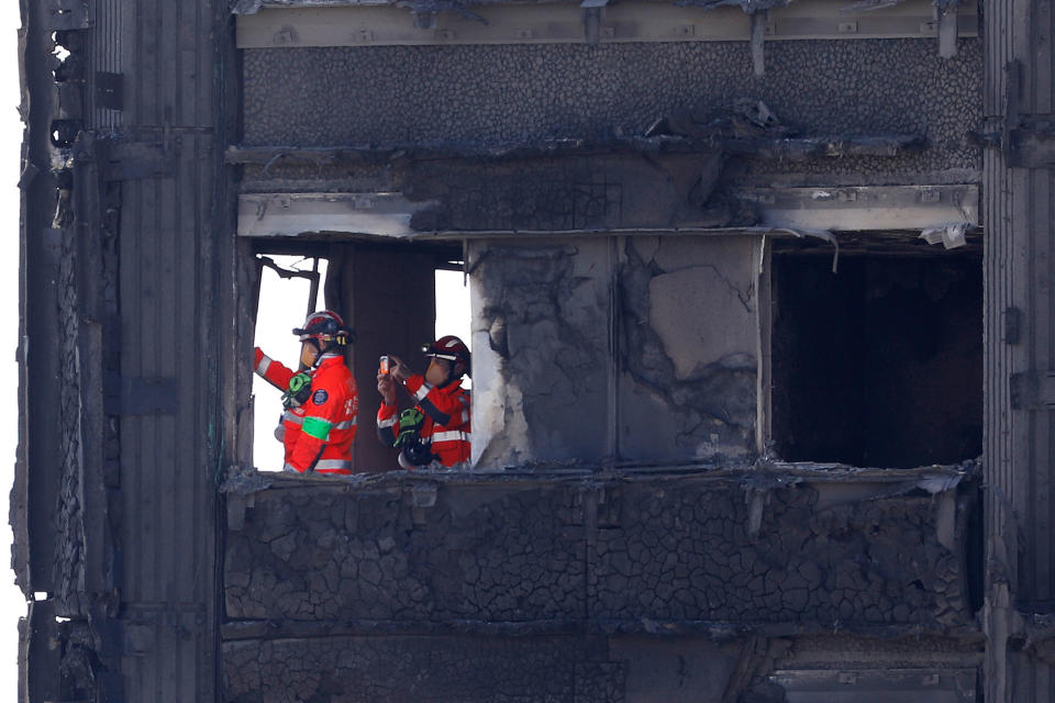 <p>Members of the emergency services work inside the charred remnains of the Grenfell Tower block in Kensington, west London, on June 17, 2017, follwing the June 14 fire at the residential building.<br> (Tolga Akmen/AFP/Getty Images) </p>