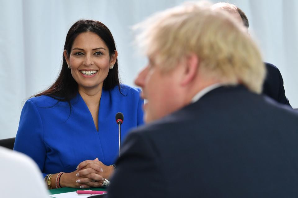 Britain's Home Secretary Priti Patel (L) looks on as Britain's Prime Minister Boris Johnson chairs a cabinet meeting at the National Glass Centre at the University of Sunderland, in Sunderland, northeast England on January 31, 2020, the day that the UK formally leaves the European Union. - Britain on January 31 ends almost half a century of integration with its closest neighbours and leaves the European Union, starting a new -- but still uncertain -- chapter in its long history. (Photo by Paul ELLIS / POOL / AFP) (Photo by PAUL ELLIS/POOL/AFP via Getty Images)