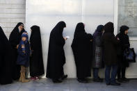 Iranians queue for voting in the parliamentary elections in a polling station in Tehran, Iran, Friday, Feb. 21, 2020. Iranians began voting for a new parliament Friday, with turnout seen as a key measure of support for Iran's leadership as sanctions weigh on the economy and isolate the country diplomatically. (AP Photo/Vahid Salemi)