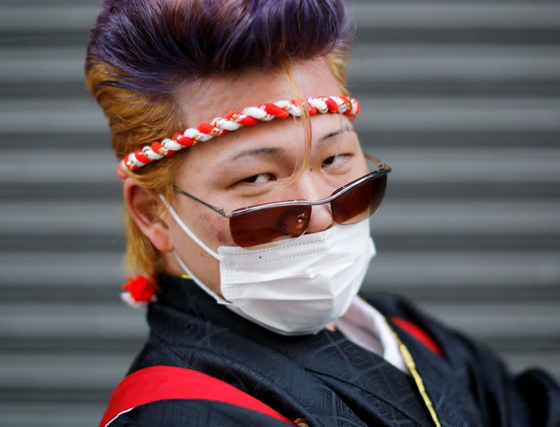 Kimono-clad man wearing a face mask poses for a photograph at Coming of Age Day celebration ceremony amid the coronavirus disease (COVID-19) outbreak, in Yokohama, Japan