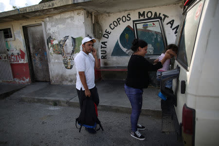 People get into a vehicle in front of a public transport office in El Junquito, Venezuela, February 15, 2019. Picture taken February 15, 2019. To match Insight VENEZUELA-POLITICS/EVIDENCE. REUTERS/Andres Martinez Casares