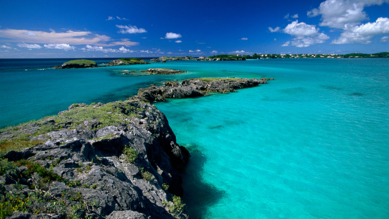  Stunning blue view of the sea along a shallow rocky coast. 