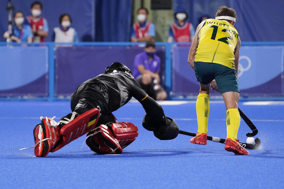 Belgium goalkeeper Vincent Vanasch, left, makes the final save against Australia's Jacob Thomas Whetton (12) during a penalty shootout to win their men's field hockey gold medal match at the 2020 Summer Olympics, Thursday, Aug. 5, 2021, in Tokyo, Japan. (AP Photo/John Minchillo)