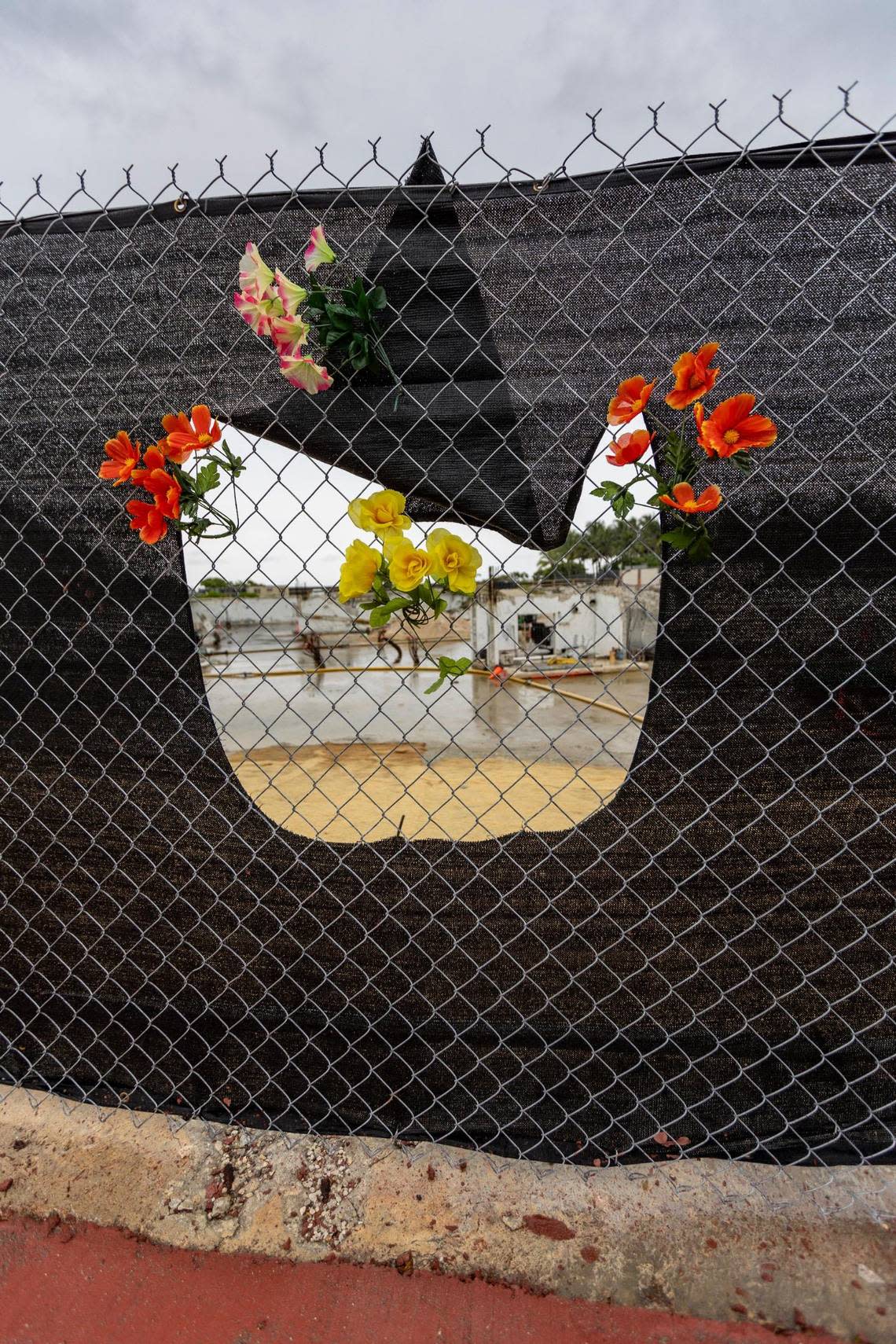 Plastic flowers at the site of Champlain Towers South, 88th Street and Collins Avenue in Surfside, June 22, 2023.