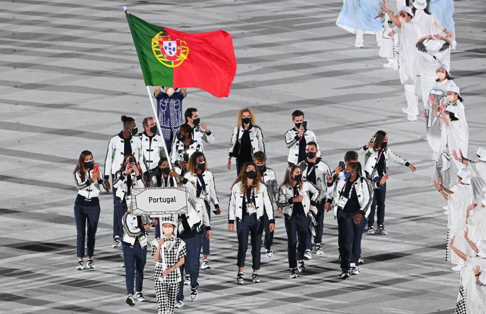 <p>Portugal's delegation parade during the opening ceremony of the Tokyo 2020 Olympic Games, at the Olympic Stadium, in Tokyo, on July 23, 2021. (Photo by Martin BUREAU / AFP) (Photo by MARTIN BUREAU/AFP via Getty Images)</p> 