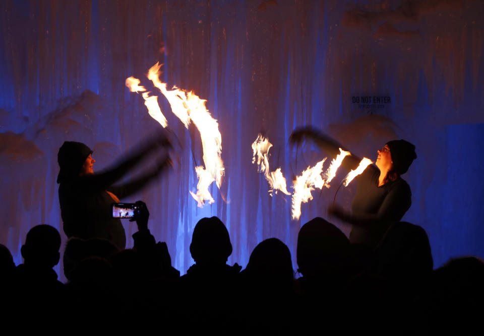 Fire dancers perform at Ice Castles in North Woodstock, N.H. The winter wonderland is one of six in North America. (Photo: Robert F. Bukaty/AP)