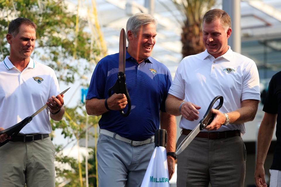 Jaguars head coach Doug Pederson (center) talks with general manager Trent Baalke (left) and Miller Electric CEO Henry Brown (right) at the practice site's opening in July.