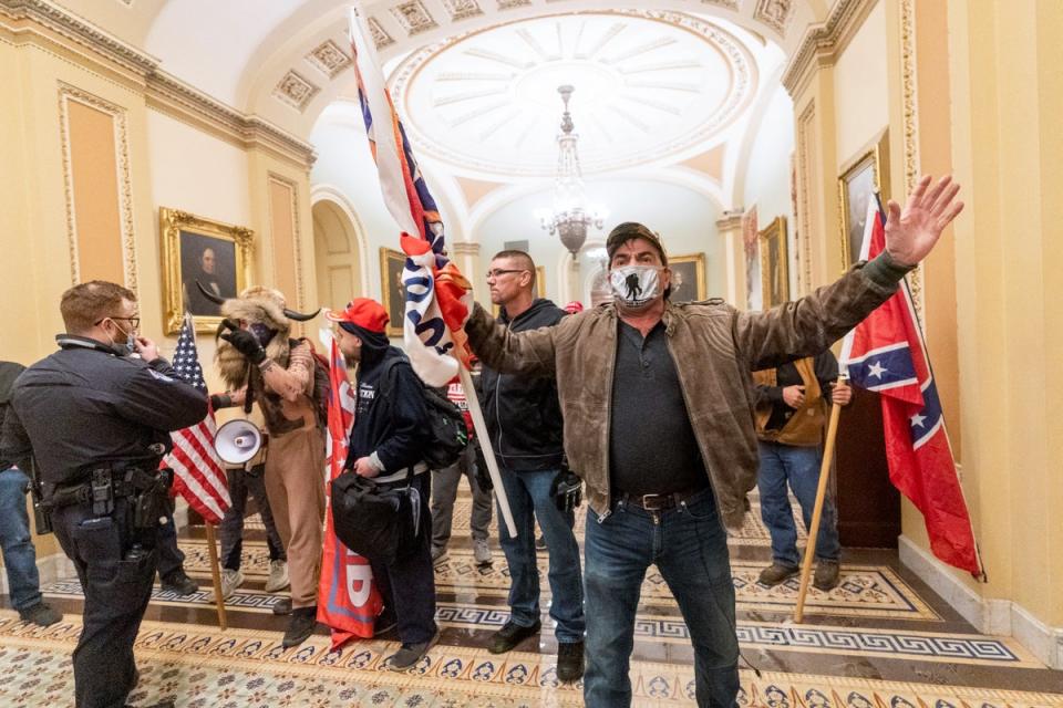 Supporters of President Donald Trump are confronted by U.S. Capitol Police officers outside the Senate Chamber inside the Capitol (AP)