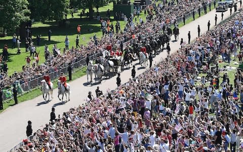 Huge crowds line the streets of Windsor - Credit: EMMANUEL DUNAND /AFP