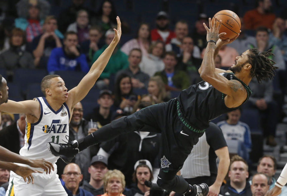 Minnesota Timberwolves' Derrick Rose, right, takes a fall-back shot as Utah Jazz's Dante Exum defends sueinf the first half of an NBA basketball game Wednesday, Oct. 31, 2018, in Minneapolis. (AP Photo/Jim Mone)