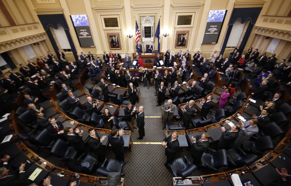 Virginia Gov. Bob McDonnell, center isle, waves to his wife as he arrives to deliver his State of the Commonwealth address before a joint session of the 2014 General Assembly at the Capitol in Richmond, Va., Wednesday, Jan. 8, 2014. McDonnell leaves office on Saturday. (AP Photo/Steve Helber)