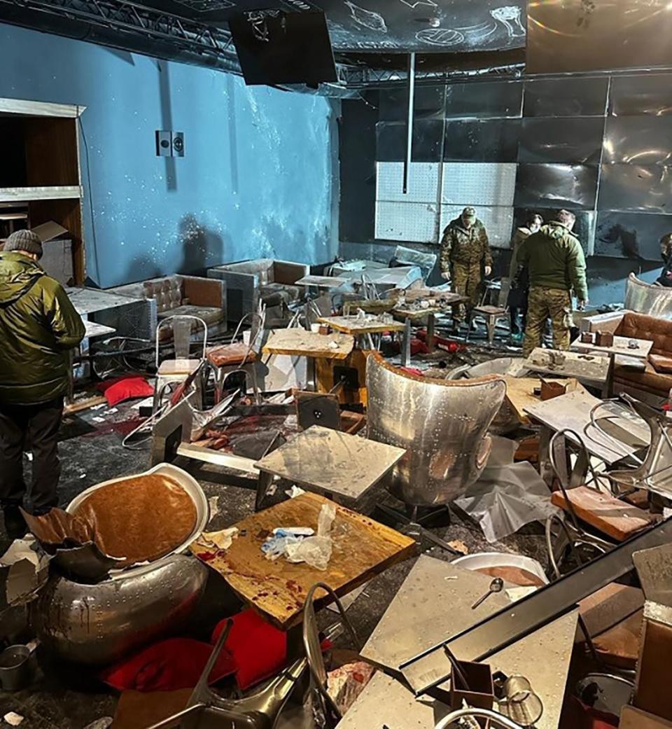 Russian investigators inspect the 'Street bar' cafe damaged in a blast in Saint Petersburg on April 2, 2023.