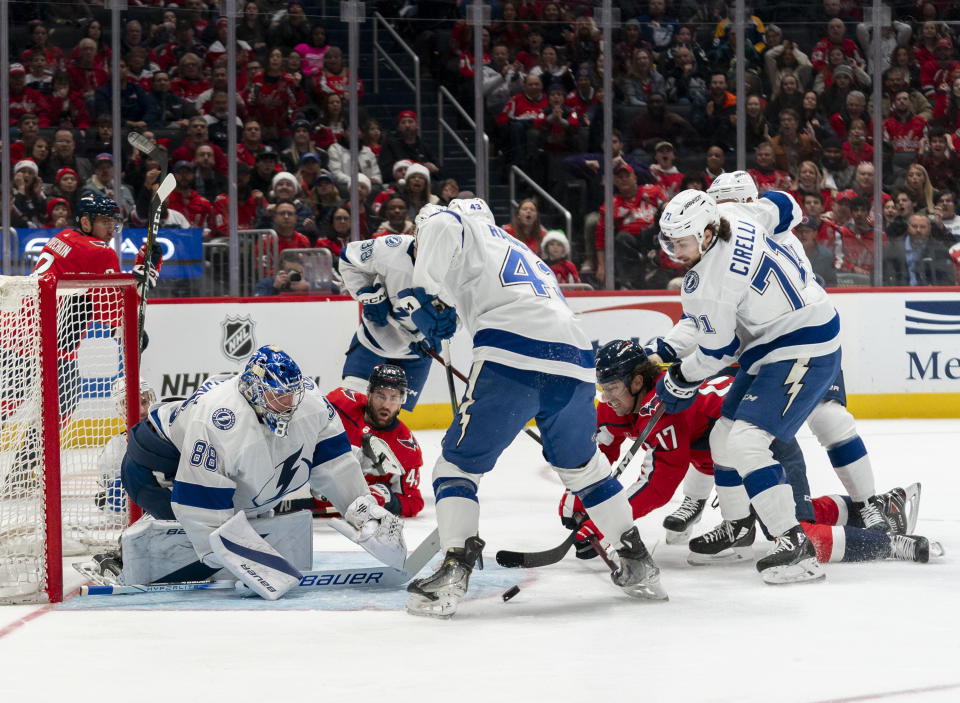 Tampa Bay Lightning goaltender Andrei Vasilevskiy (88) deflects a shot by Washington Capitals center Dylan Strome (17) during the first period of an NHL hockey game, Saturday, Dec. 23, 2023, in Washington. (AP Photo/Stephanie Scarbrough)