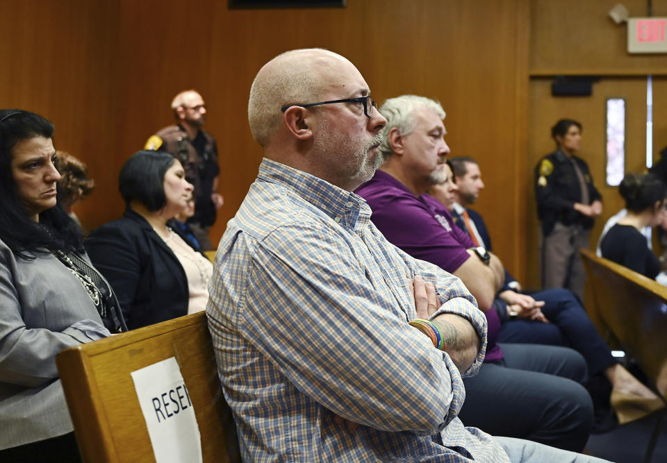 Parents of shooting victims, Craig Shilling, foreground, and Steve St. Juliana, background listen to former Oakland County Det. Edward Wagrowski testify during Jennifer Crumbley's trial at the Oakland County Courthouse, Friday, Jan. 26, 2024, in Pontiac, Mich. Crumbley, 45, is on trial for involuntary manslaughter, the first time parents have been charged in a U.S. mass school shooting. She and her husband are accused of contributing to the deaths at Oxford High School by neglecting their son's needs and making a gun accessible at home. (Clarence Tabb Jr./Detroit News via AP, Pool)