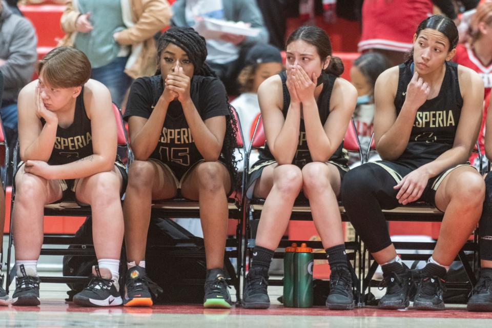 The Hesperia girls basketball team reacts as teammate Elizabeth Sanchez is treated by paramedics on Friday night. Sanchez fell during the fourth quarter and was taken to a local trauma center.