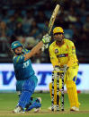 Pune Warriors India batsman Steven Smith (L) watched by Chennai Super Kings cricketer Mahendra Singh Dhoni plays a shot during the IPL Twenty20 cricket match between Pune Warriors India and Chennai Super Kings at The Subrata Roy Sahara Stadium in Pune on April 14, 2012. AFP PHOTO/Indranil MUKHERJEE RESTRICTED TO EDITORIAL USE. MOBILE USE WITHIN NEWS PACKAGE (Photo credit should read INDRANIL MUKHERJEE/AFP/Getty Images)