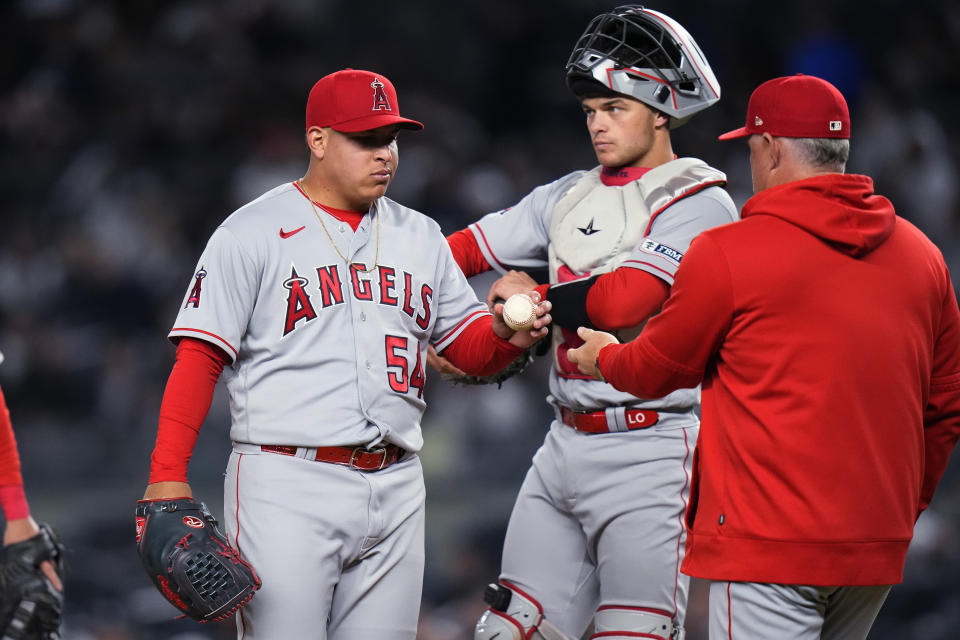 Los Angeles Angels starting pitcher Jose Suarez hands the ball to manager Phil Nevin as he leaves during the fourth inning of the team's baseball game against the New York Yankees on Tuesday, April 18, 2023, in New York. (AP Photo/Frank Franklin II)