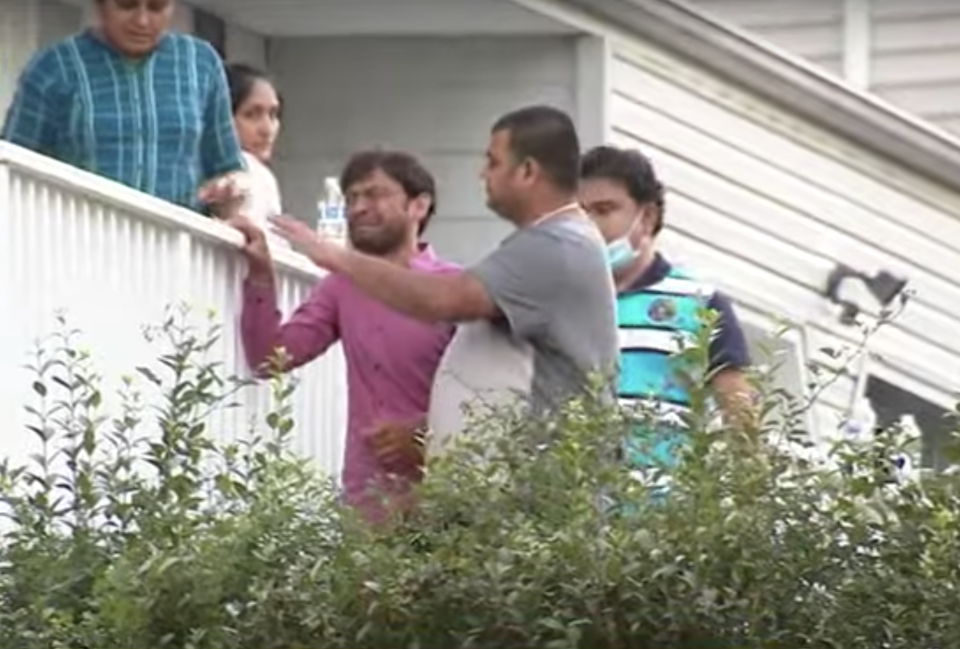 Family members cry outside a New Jersey home after three people drowned.