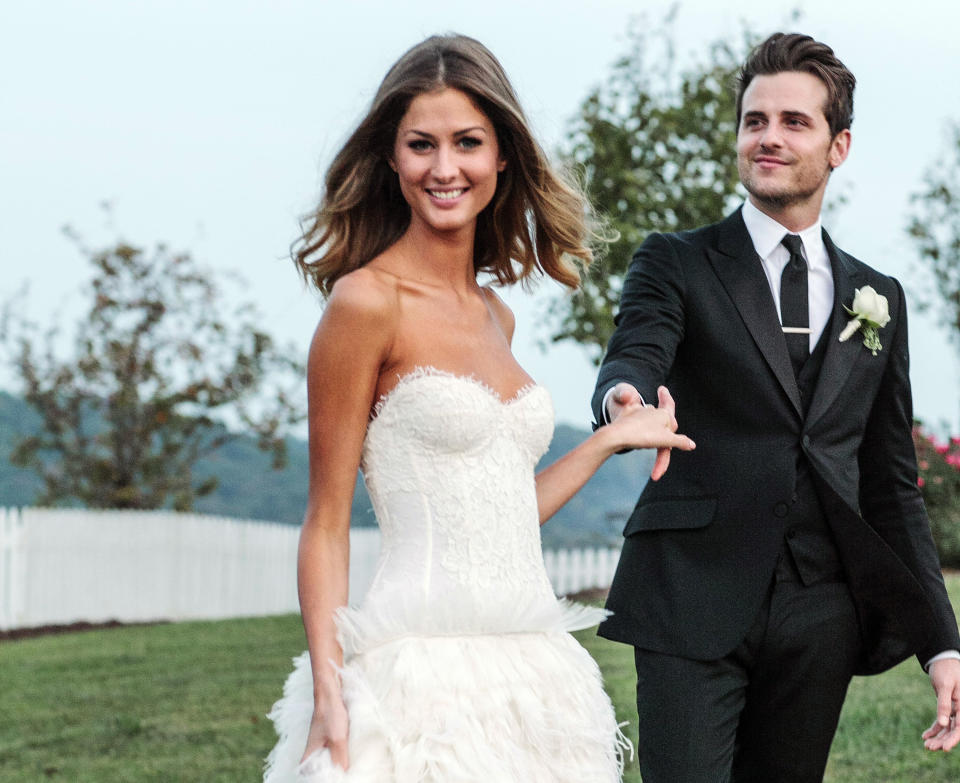 This Saturday, Sept. 29, 2012 image released by Michael Howard shows Kings of Leon bassist Jared Followill and model Martha Patterson at their wedding in Charlotte, Tenn. The couple married Saturday evening during a ceremony with friends and family at Front Porch Farms, about 40 miles outside Nashville. The 25-year-old Followill and 21-year-old Patterson were engaged last spring. Patterson wore a white dress with lace bodice and flowing feathered skirt by Monique Lhuillier and Followill wore black Gucci. (AP Photo/Michael Howard)