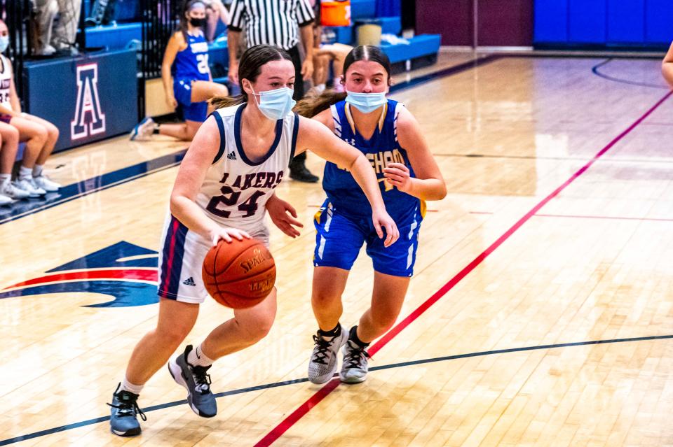 Apponequet's Riley Levrault drives past Wareham's Carly Glover.