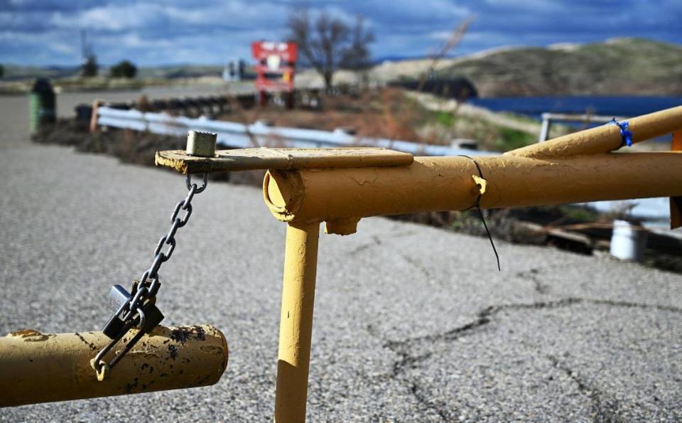 A locked gate prevents the public from driving into the parking lot to Friant Dam at Millerton Lake, photographed Tuesday, Jan. 23, 2024 near Friant, CA.