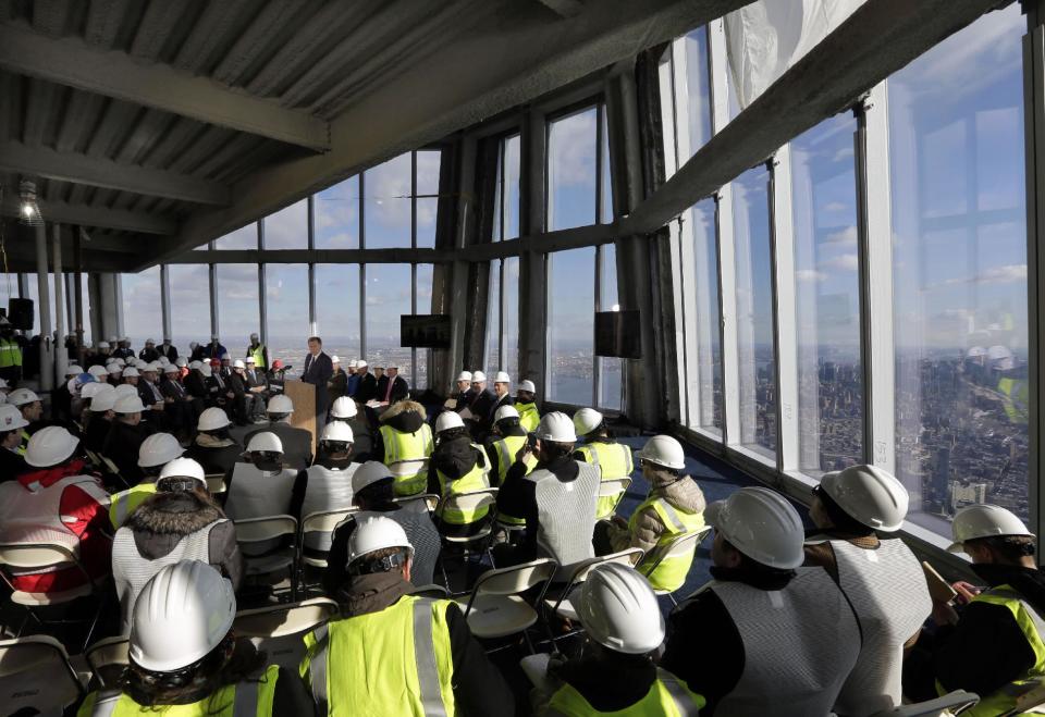 Port Authority Chairman David Samson, at podium center left, addresses a news conference in observation deck on the 100th floor of the One World Trade Center building, under construction in New York, Tuesday, April 2, 2013. The observation deck will occupy the tower's 100th through 102nd floors. Elevators will whisk visitors to the top in just one minute but the experience of visiting the attraction will take an hour. (AP Photo/Richard Drew)