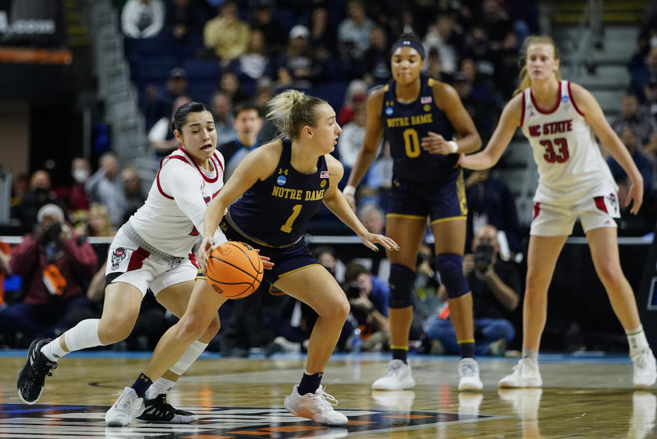 North Carolina State guard Raina Perez (2) strips the ball from Notre Dame guard Dara Mabrey (1) for a steal late in the fourth quarter of a college basketball game in the Sweet Sixteen round of the NCAA women's tournament, Saturday, March 26, 2022, in Bridgeport, Conn. (AP Photo/Frank Franklin II)