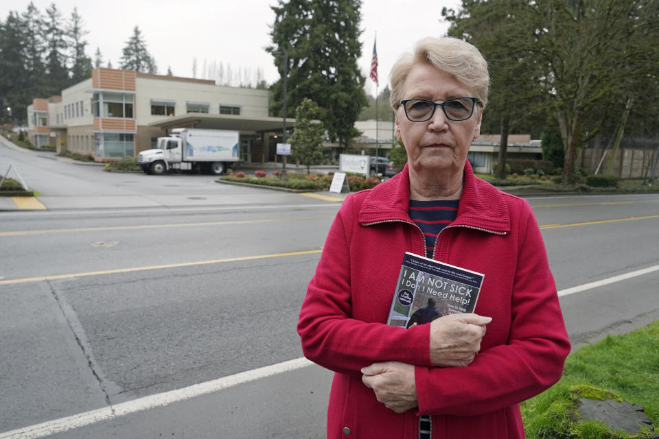 Diane Ostrander poses for a photo, Thursday, Jan. 20, 2022, in Kirkland Wash., near the behavioral health hospital where her son is being treated. For months, Ostrander worried desperately about her son as he faced a mental-health crisis, but the police Ostrander begged for help relayed a consistent message: A new state law meant officers couldn't take her son to get help against his will, even though mental health professionals and a judge ordered it. (AP Photo/Ted S. Warren)