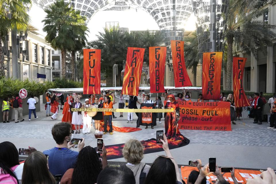 Activists protest against fossil fuels at the COP28 U.N. Climate Summit, Tuesday, Dec. 5, 2023, in Dubai, United Arab Emirates. (AP Photo/Peter Dejong)