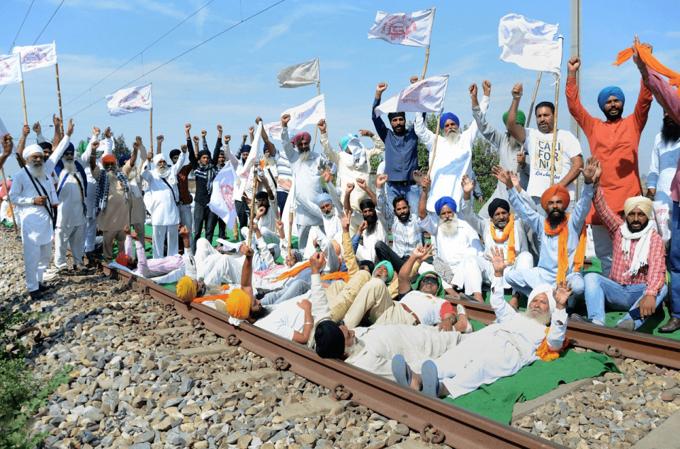 <div class="paragraphs"><p>Amritsar: Farmers block railway tracks as part of the Samyukt Kisan Morcha's rail roko protest demanding the dismissal and arrest of Union Minister Ajay Mishra in connection with the 3 October violence in Lakhimpur Kheri, at Devi Dass Pura in Amritsar district</p></div>