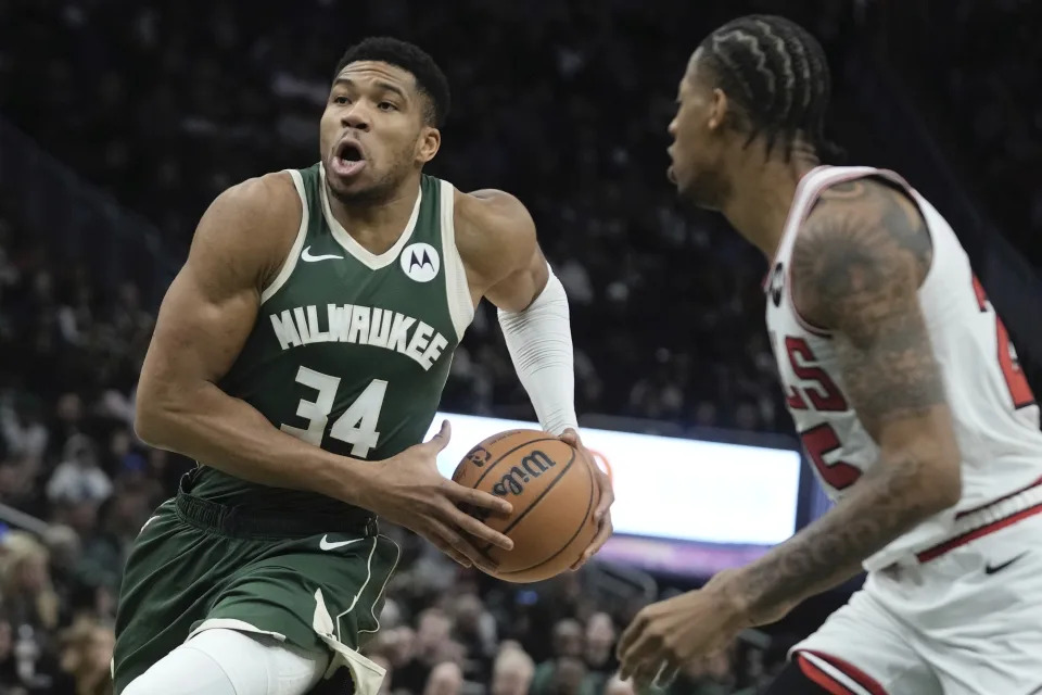 Milwaukee Bucks' Giannis Antetokounmpo drives past Chicago Bulls' Dalen Terry during the first half of an NBA basketball game Monday, Dec. 11, 2023, in Milwaukee. (AP Photo/Morry Gash)