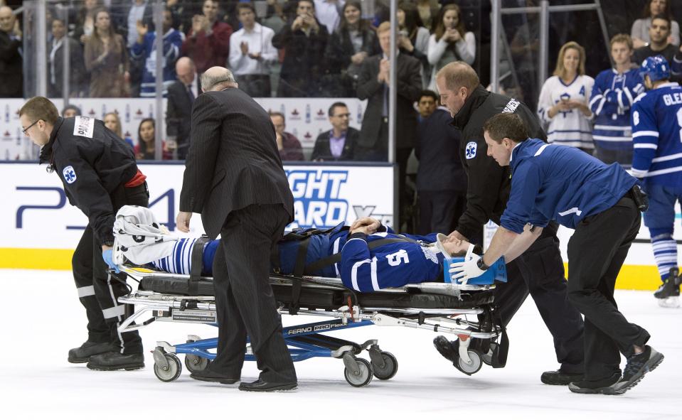 Toronto Maple Leafs' Paul Ranger is taken off the ice on a stretcher after hitting the boards head first from a check by Tampa Bay Lightning's Alex Killorn during first period NHL action in Toronto on Wednesday March 19, 2014. (AP Photo/The Canadian Press, Frank Gunn)
